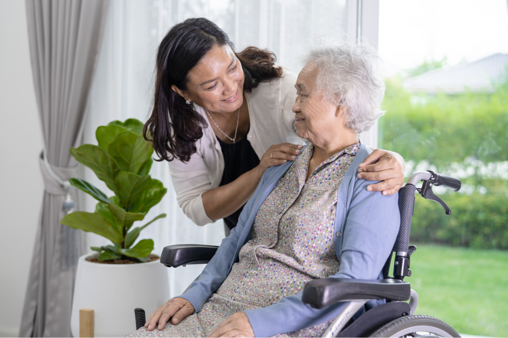 A woman caring for her mother in a wheelchair.