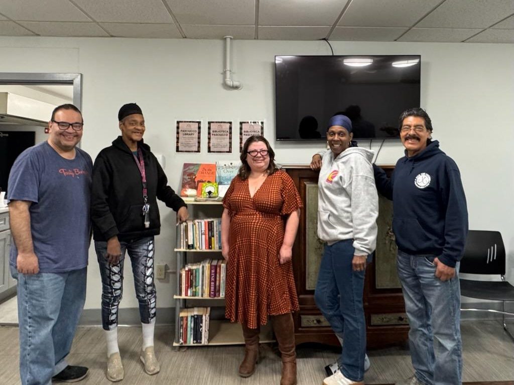 Georgia Titonis, Uphams Corner Branch Librarian of the Boston Public Library, center, with Pasciucco residents.